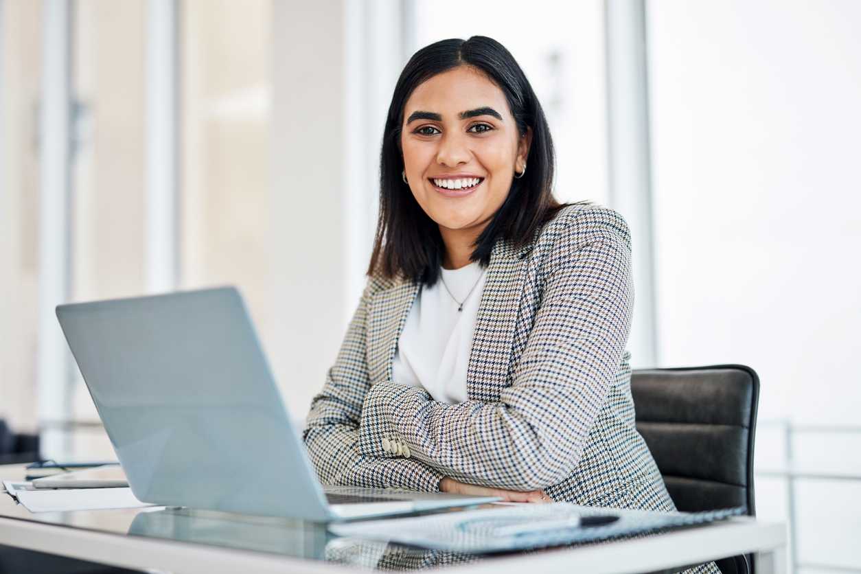 Woman smiling at a desk
