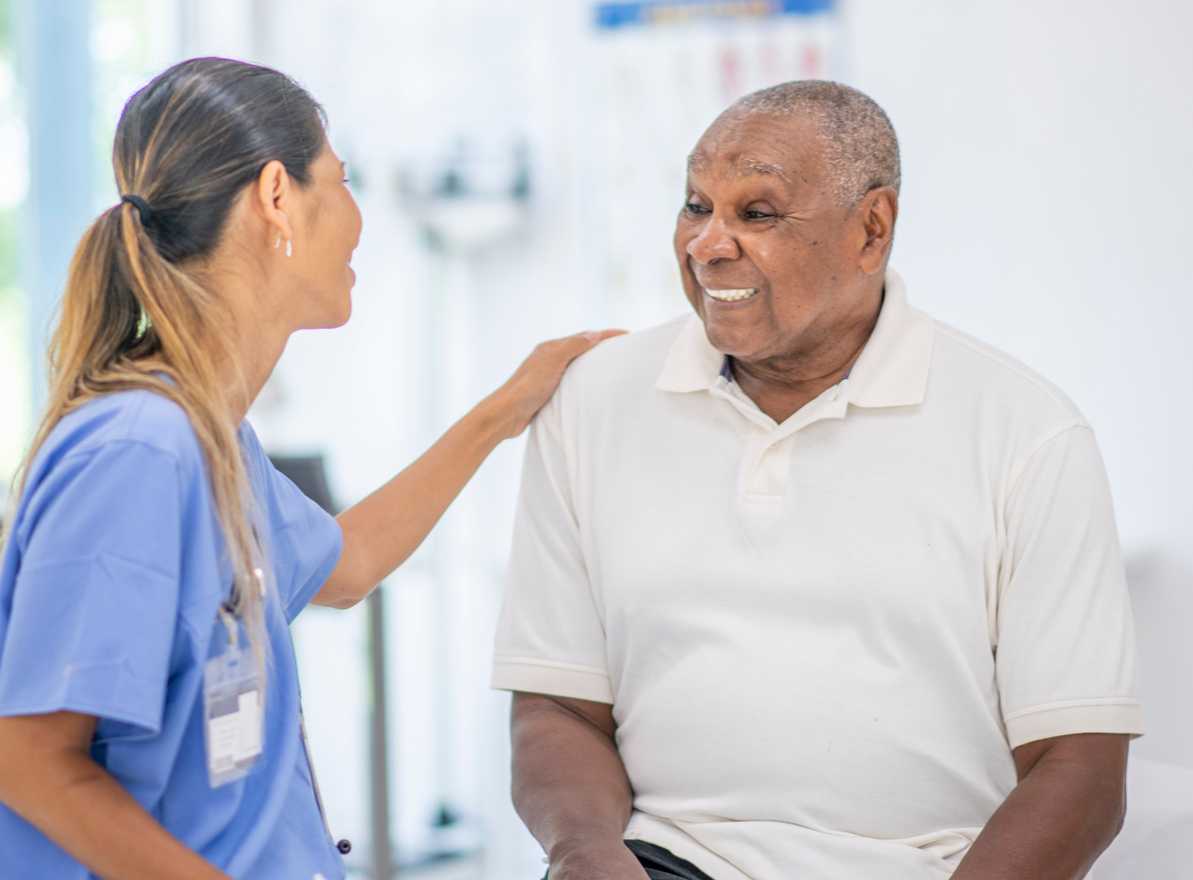 senior citizen at doctor's office with caring medical professional