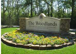 a landsacaped sign for The Woodlands, TX
